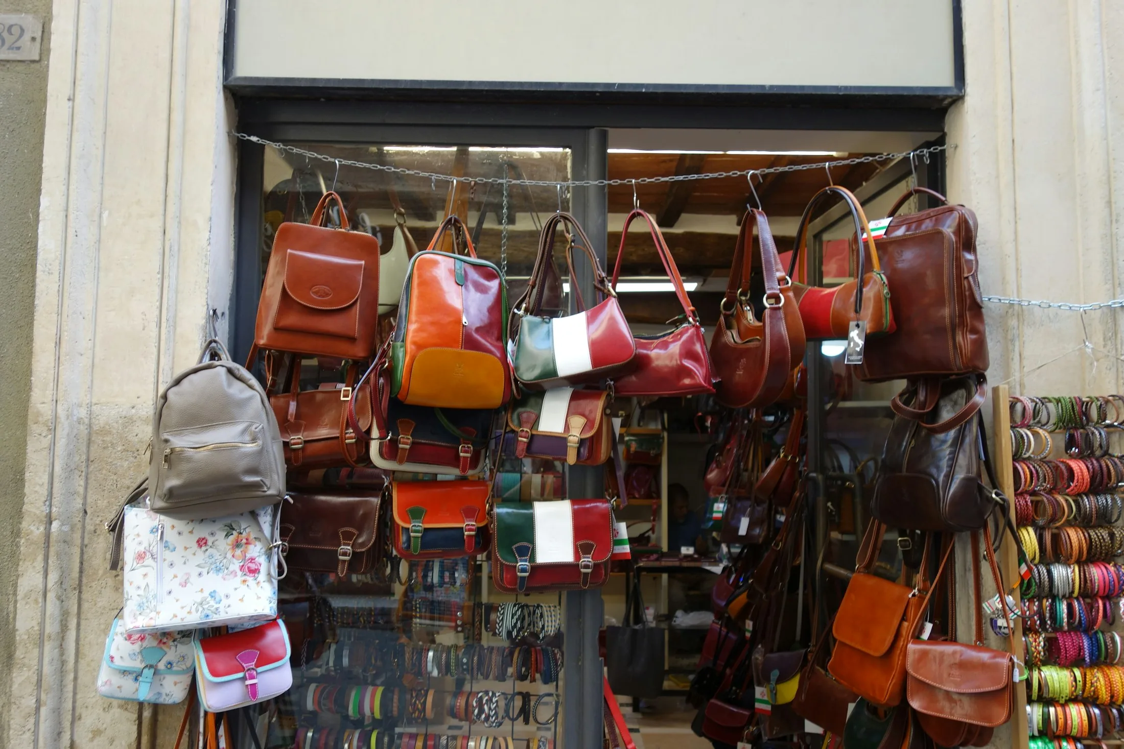 Leather bags and accessories arranged outside a shop