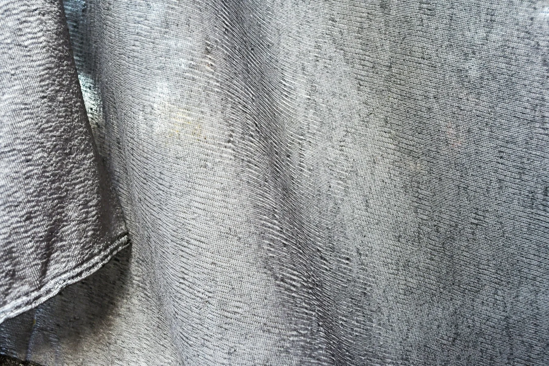 Gray woven textile with stitching detail